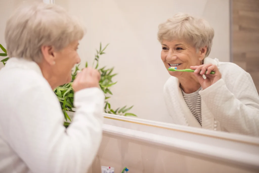 A person gently brushing teeth with a soft-bristled toothbrush.